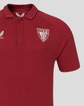 Close up of chest on a red polo showing Athletic Club Bilbao crest on the left and Castore logo on the right.