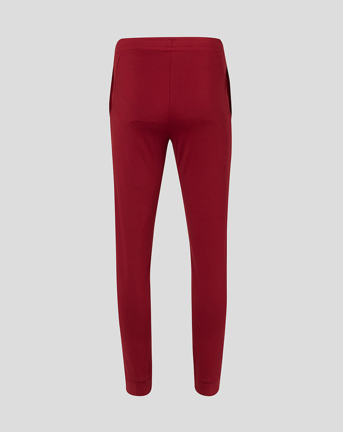 Front view of red Tech Fleece jog pants for men with a small white emblem on the thigh