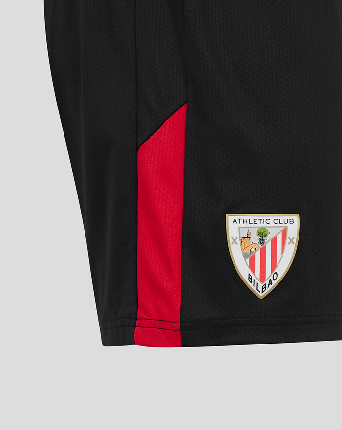 Close-up of black shorts with red side panel and Athletic Club Bilbao crest near the hem