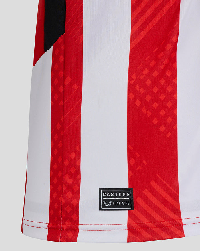 Lower front of red and white striped jersey showing Castore label patch near the hem