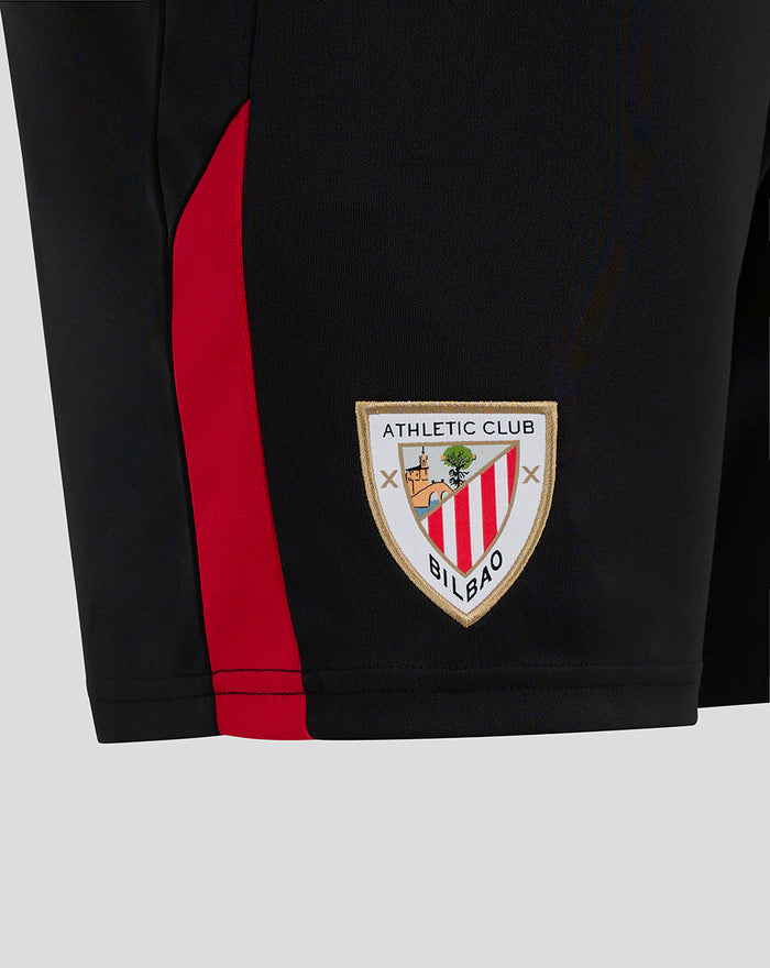 Close up of black shorts showing a red side stripe and the Athletic Club Bilbao crest near the hem.