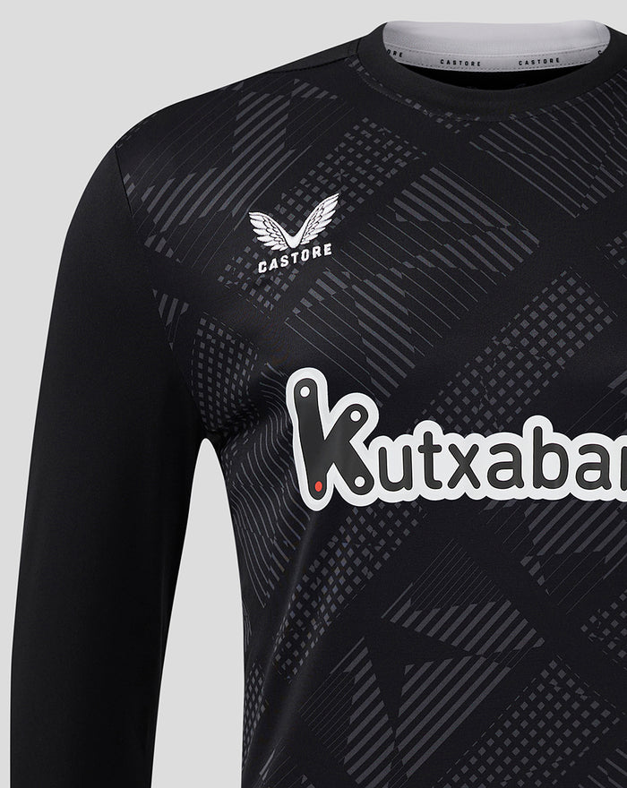 Close-up of chest area showing Castore branding near the shoulder, Athletic Club crest, and Kutxabank sponsor on a dark geometric goalkeeper jersey.