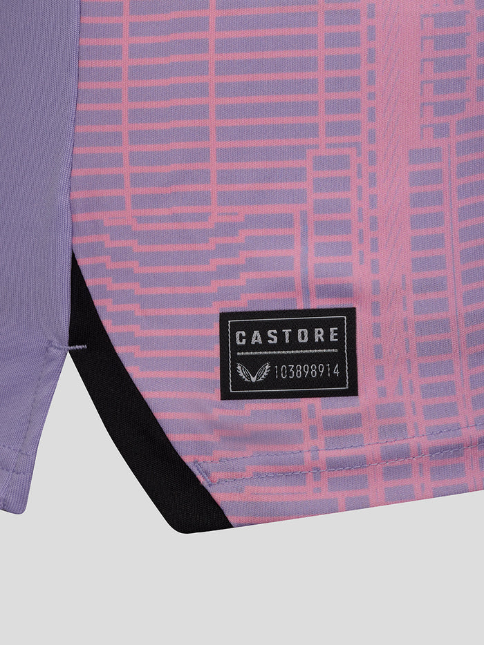 Close-up of purple shirt fabric showing pink geometric print and CASTORE label on the lower back area.