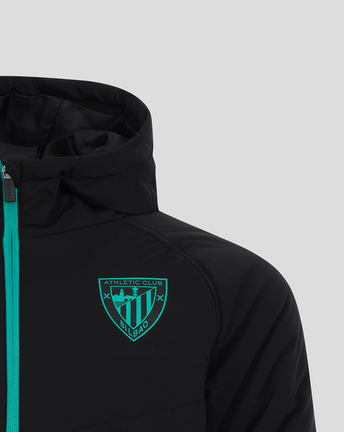 Close up of the teal Athletic Club Bilbao crest on the chest of the black jacket with turquoise zipper.