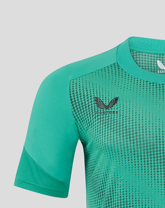 Close up of shoulder and neckline of teal drill tee showing knit texture and chest logo.