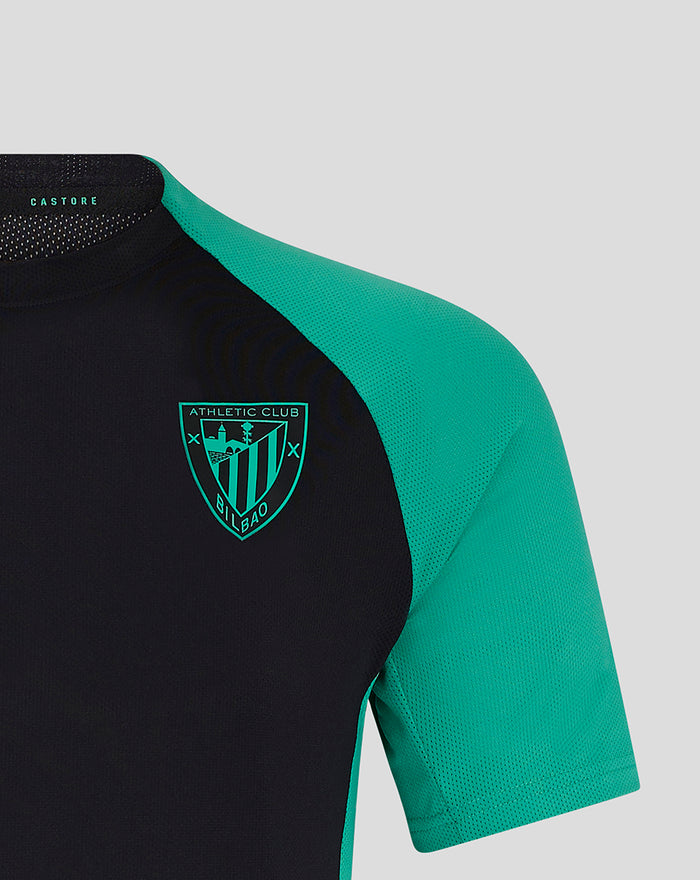 Shoulder and chest of junior coaches shirt with teal sleeve and club crest on left chest