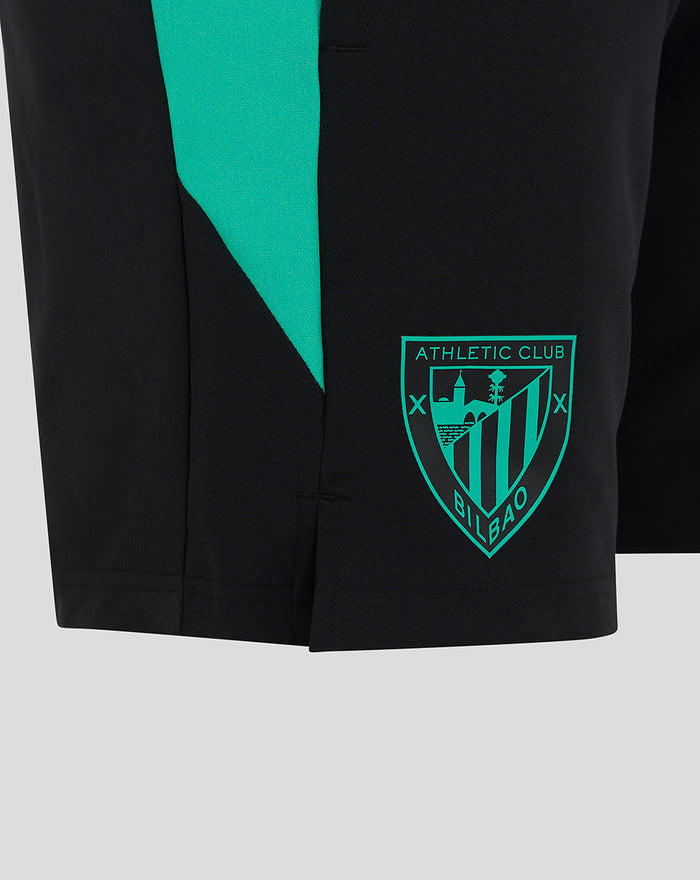 Black junior woven shorts with teal diagonal panel and crest patch