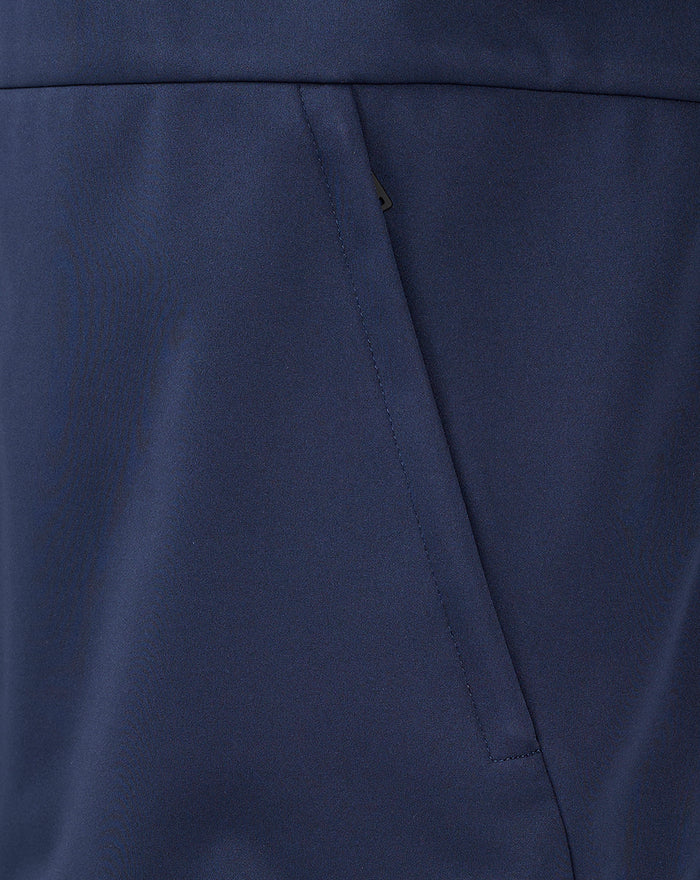Navy junior travel jacket pocket detail showing angled opening and panel stitching