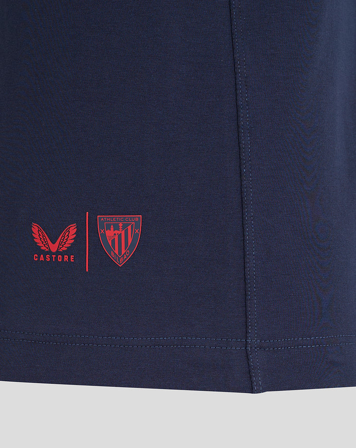 Navy travel polo fabric with Castore wing logo and Athletic Club crest on the lower left hem