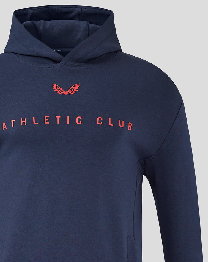 Close-up of navy junior Travel Logo Hoodie chest with red crest and Athletic Club branding.