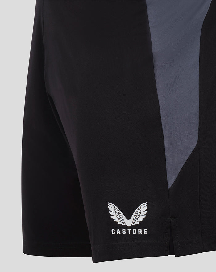 Back side view of black GK training shorts showing a gray side panel and Castore logo near the hem.