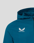 Front view of teal GK training rain jacket with hood showing embossed chest logo
