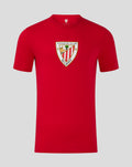 Front view of a red men's core crest tee with a large shield emblem centered on the chest