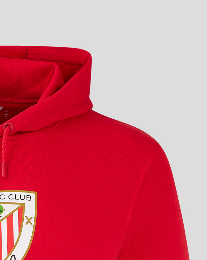 Close-up of red hoodie showing hood opening and partial crest emblem