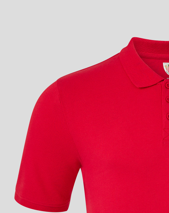Close-up of red polo shirt shoulder and collar seam.