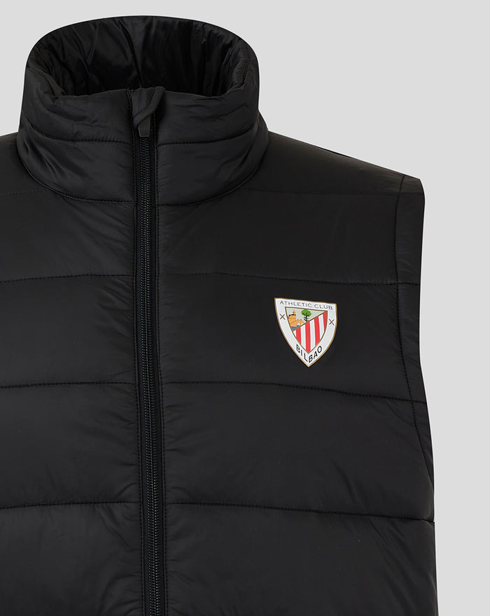 Close up of the black padded gilet showing the zipper and left chest crest badge
