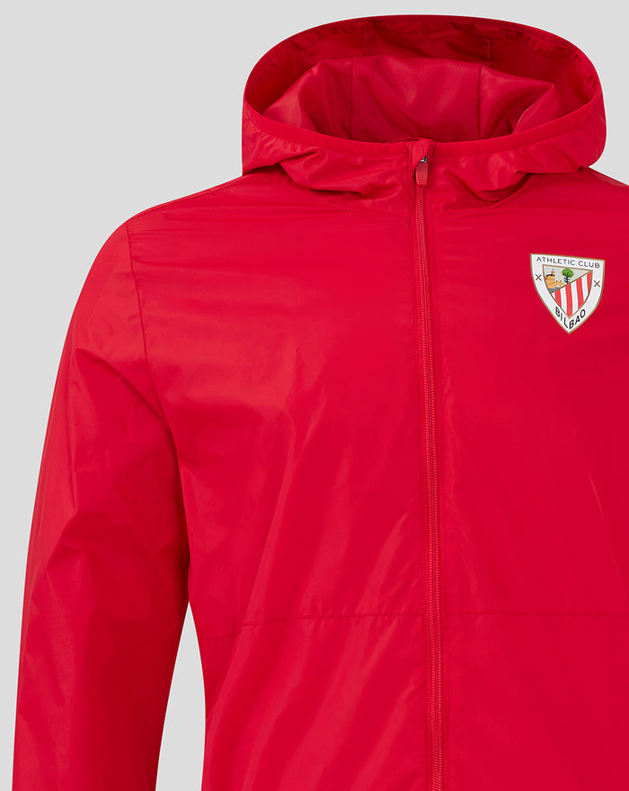 Close up of red Men's Core Summer Jacket with zip front and crest on the left chest.