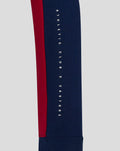 Close up of sleeve showing vertical Athletic Club X Castore text on navy fabric with red stripe