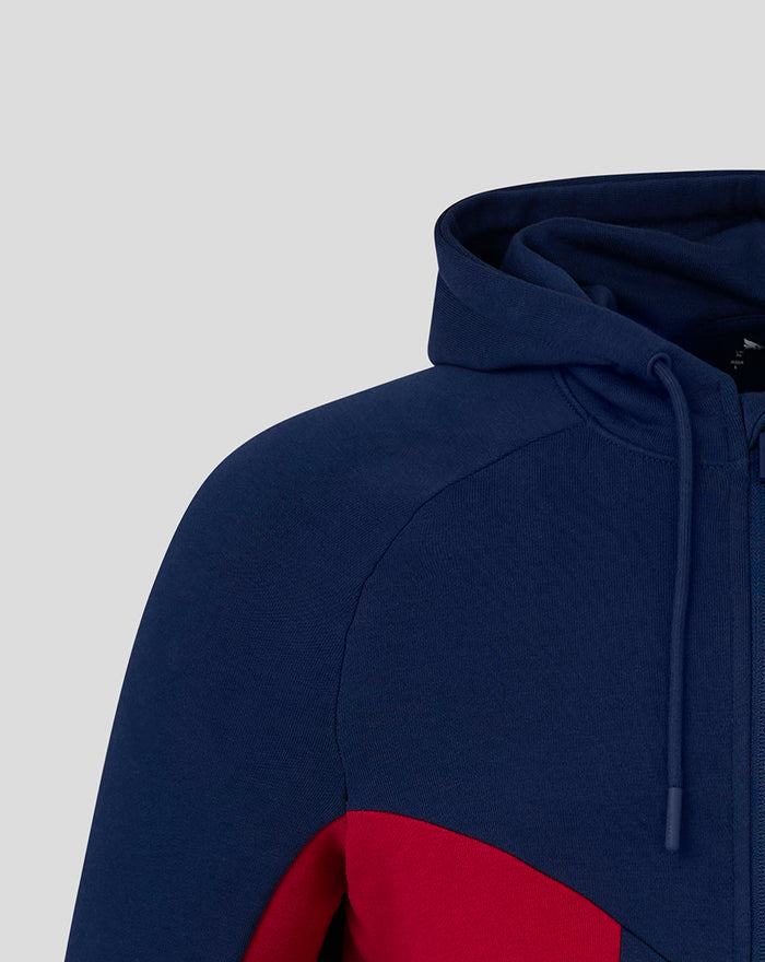 Close up of navy hooded fleece showing shoulder seam and a red side panel