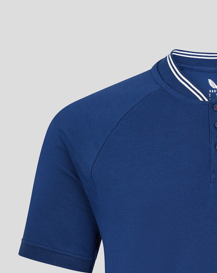 Detail of blue polo collar with white striped trim and shoulder seam.