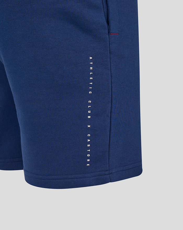Blue athletic club shorts with vertical white branding along the side seam.
