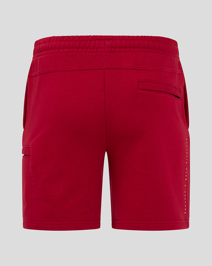 Back view of red athletic club shorts with an elastic waistband and a single back welt pocket.