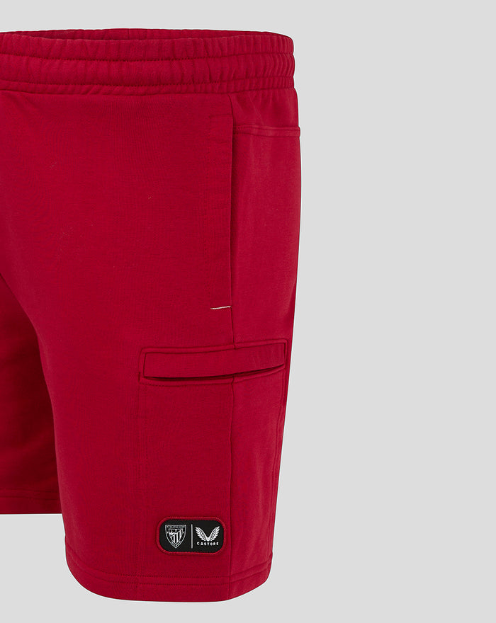 Back-right panel of red athletic club shorts featuring a welt pocket and visible stitching.