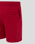 Side view of red athletic club shorts with a side cargo pocket and vertical branding along the leg.
