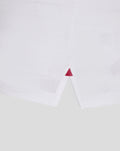 White athletic club cotton tee hem close up with a small red triangle stitch at the side
