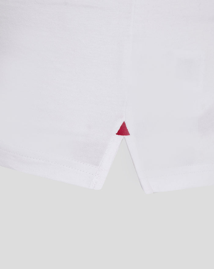White athletic club cotton tee hem close up with a small red triangle stitch at the side