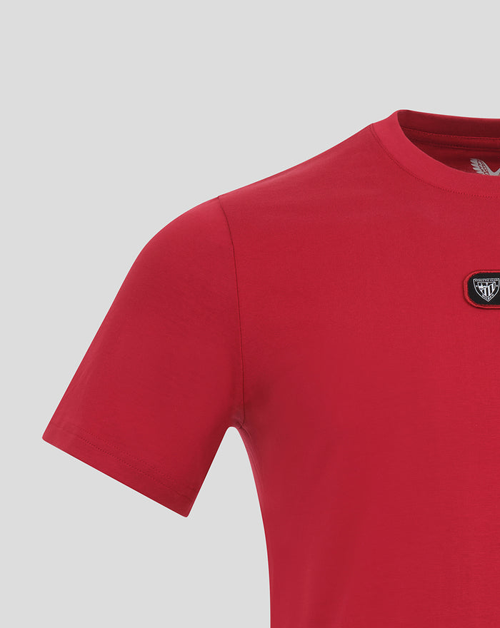 Close up of a red Athletic Club cotton tee showing sleeve and shoulder detail.