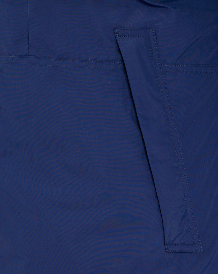Back view of blue athletic jacket showing a diagonal pocket flap detail.