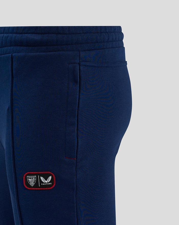 Navy men's club jogger with elastic waistband and a red bordered crest patch on the lower leg