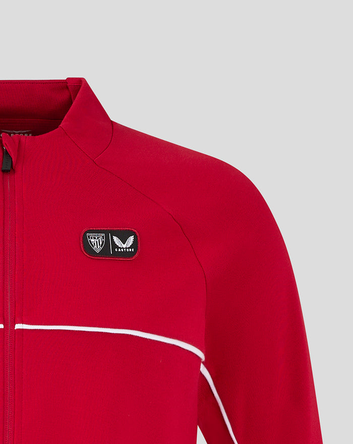 Athletic Club Track Top close up with chest patch logos and white piping on red fabric.