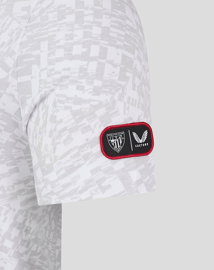 Sleeve patch on grey camo tee showing athletic club shield and Castore logo in a red bordered patch.