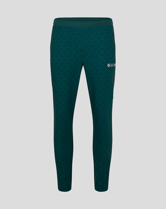 Full-length view of green travel track pants with a subtle pattern and a small Castore logo on the thigh