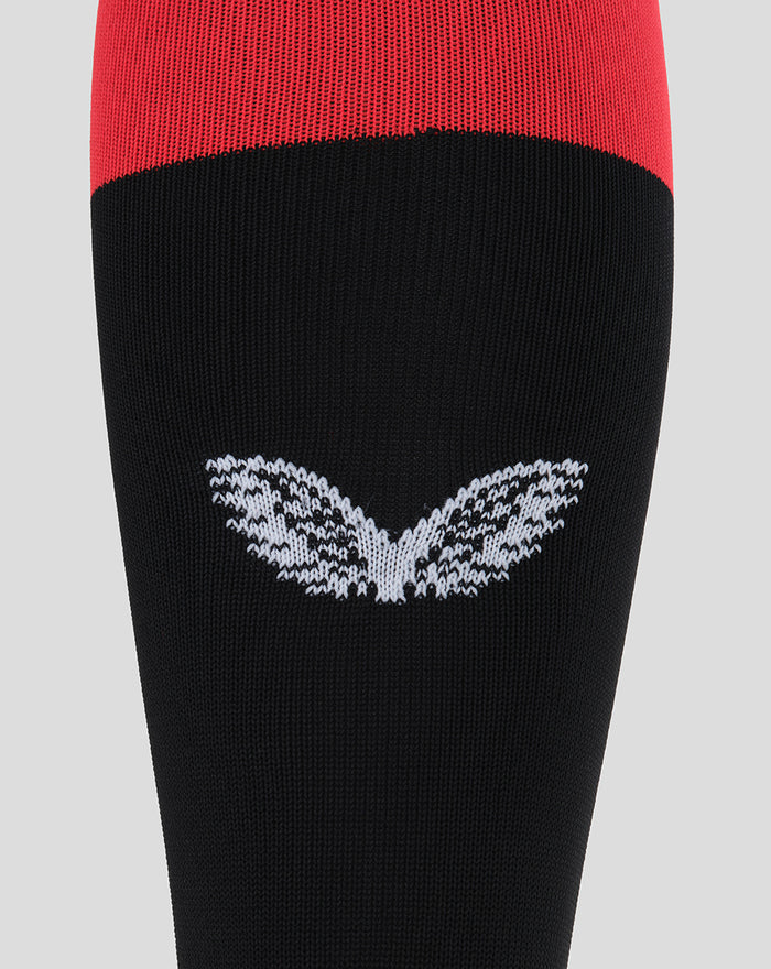 Athletic Club Fourth sock close-up showing red upper and black body with a white knit winged emblem.