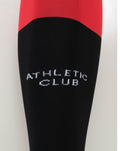 Close-up of Athletic Club Fourth Sock showing red top and black lower section with diagonal color transition.
