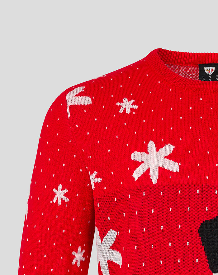 Red knit Christmas jumper with white snowflakes and small white dots