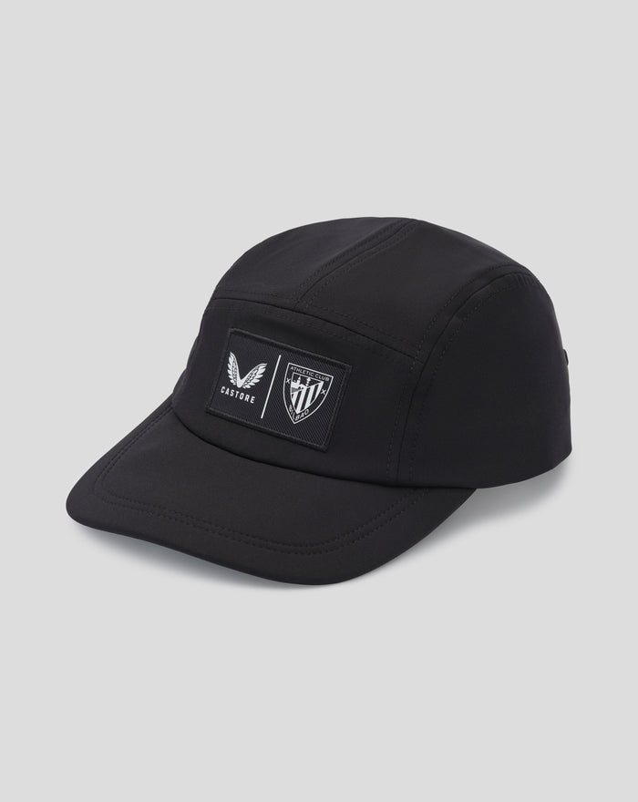 Close up of black Club Cap Dual Castore front patches featuring winged emblem and shield crest
