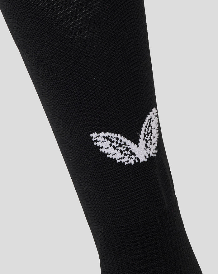 Close-up of black sock with white Athletic Club wing logo.
