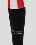 Close-up of black knee-high sock with white Athletic Club logo on the calf area.