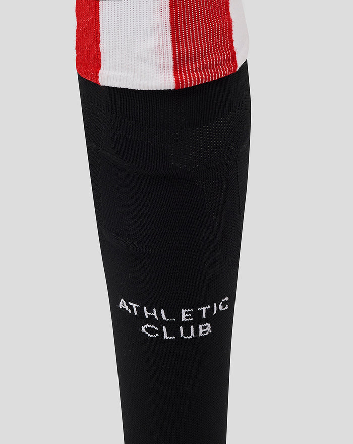 Close-up of black knee-high sock with white Athletic Club logo on the calf area.
