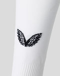 Close up of the black wing emblem on white athletic club sock fabric