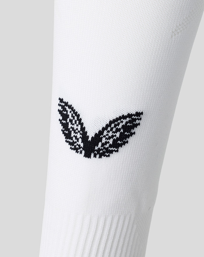 Close up of the black wing emblem on white athletic club sock fabric