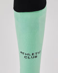 Mint green Athletic Club third sock with black foldover cuff and branding on shin and calf