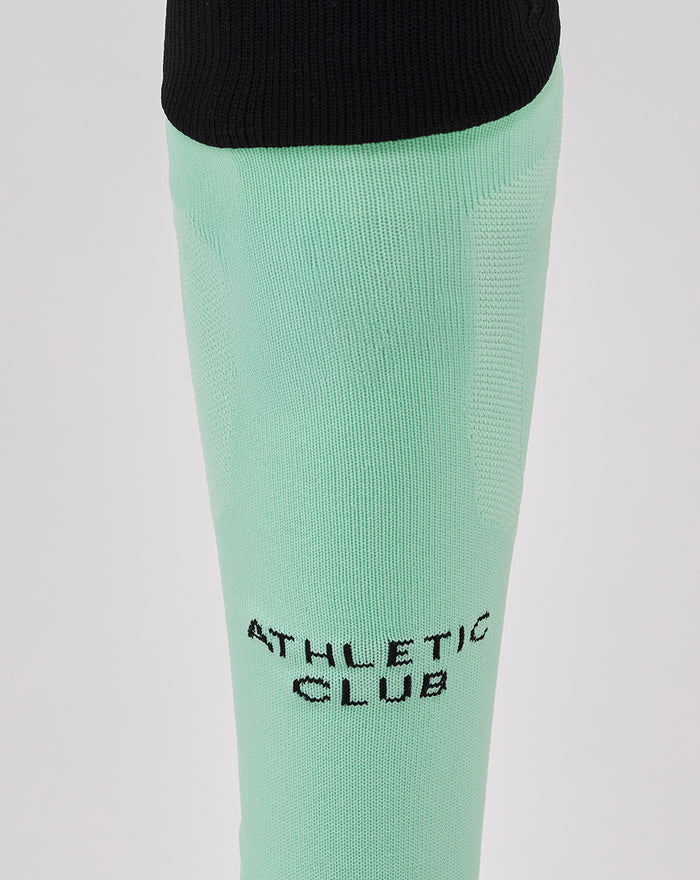 Mint green Athletic Club third sock with black foldover cuff and branding on shin and calf
