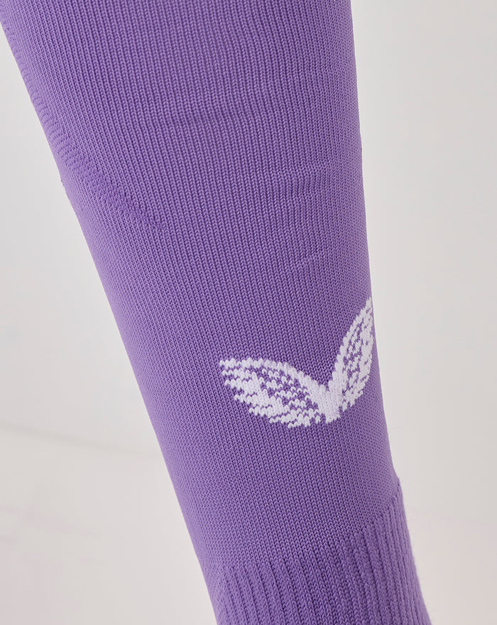 Purple Athletic Club third goalkeeper sock on leg with white branding on the shin and knit texture