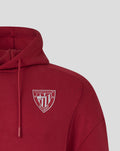 Left chest close up of red Athletic Club Travel Overhead Hoodie showing white crest logo.