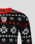Close up of the Athletic Club Christmas jumper showing the crest on the chest and a knit pattern of soccer balls and snowflakes